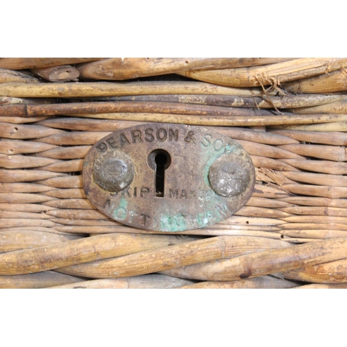 414 - An early 20th century wicker laundry basket by Pearson & Son, Nottingham, the hinged cover with leat... 