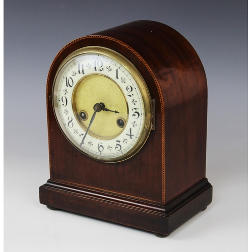 577 - An Edwardian mahogany mantel clock, of domed form, the case with inlaid chevron stringing, enclosing... 