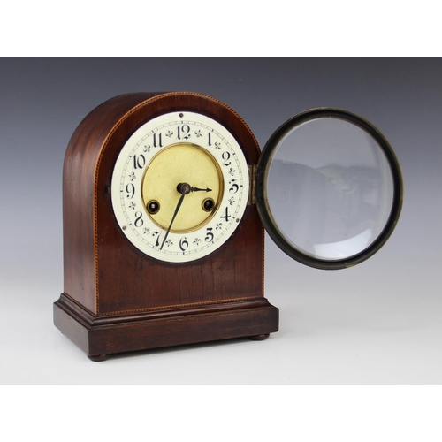 577 - An Edwardian mahogany mantel clock, of domed form, the case with inlaid chevron stringing, enclosing... 