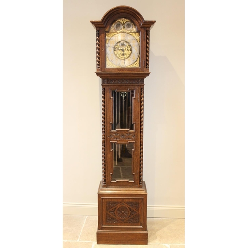 586 - An early 20th century oak cased Westminster chime longcase clock, the arched hood with barley twist ... 