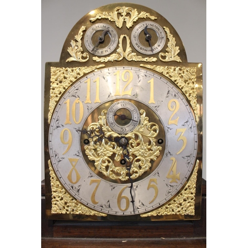 586 - An early 20th century oak cased Westminster chime longcase clock, the arched hood with barley twist ... 