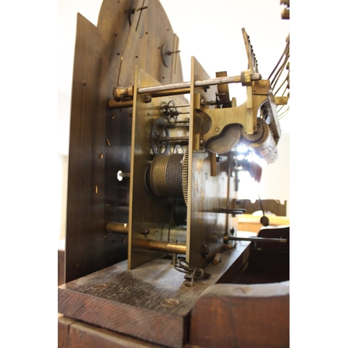 586 - An early 20th century oak cased Westminster chime longcase clock, the arched hood with barley twist ... 