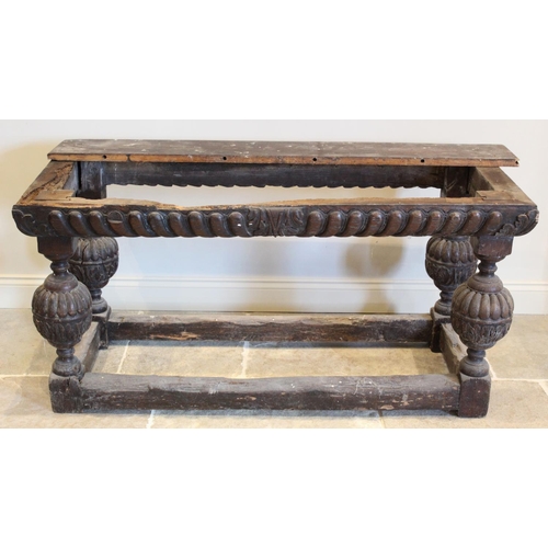 596 - A 17th century and later oak table, the associated later plank top above a gadrooned frieze raised u... 