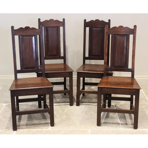 601 - A set of six 18th century style oak dining chairs, late 19th/early 20th century, each with a panel b... 