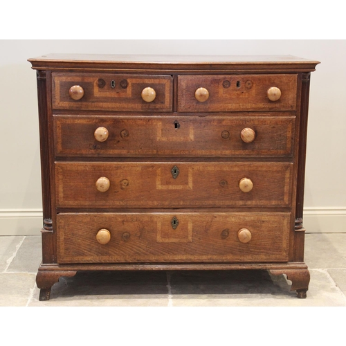 607 - A mid 18th century oak and cross banded chest of drawers, with an arrangement of two short and three... 