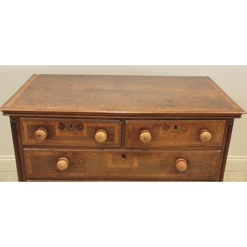 607 - A mid 18th century oak and cross banded chest of drawers, with an arrangement of two short and three... 