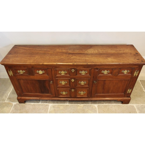 609 - A mid 18th century fruitwood dresser base, the rectangular moulded top above three central invert mo... 