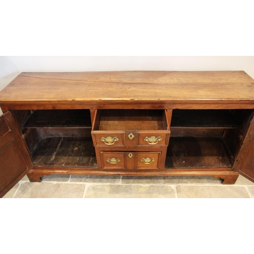 609 - A mid 18th century fruitwood dresser base, the rectangular moulded top above three central invert mo... 