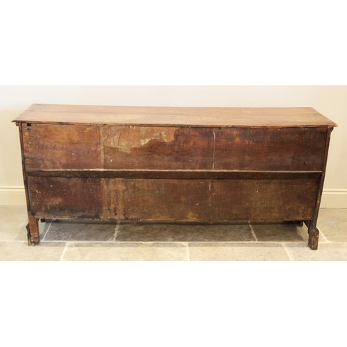 609 - A mid 18th century fruitwood dresser base, the rectangular moulded top above three central invert mo... 