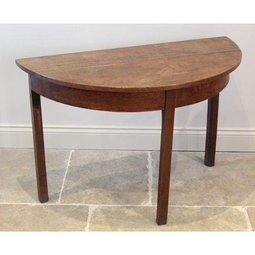 619 - A George III honey oak D-end side table, the bow front top raised upon legs of square section, 72cm ... 