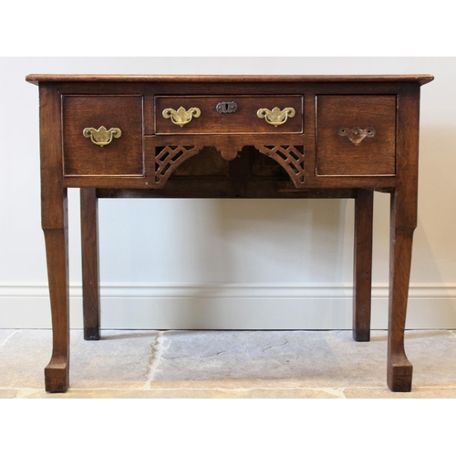 621 - A George III and later oak low boy, the rectangular moulded plank top over a central frieze drawer f... 