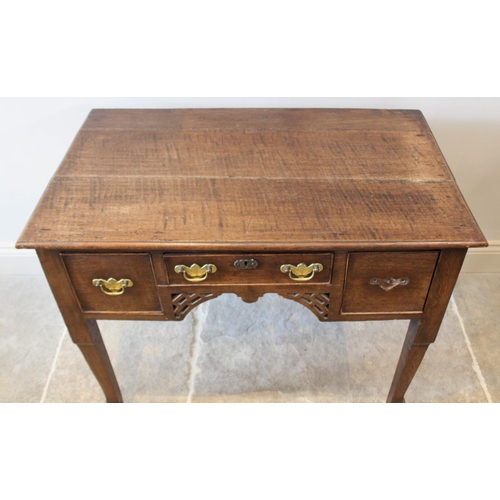 621 - A George III and later oak low boy, the rectangular moulded plank top over a central frieze drawer f... 