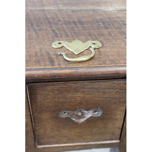 621 - A George III and later oak low boy, the rectangular moulded plank top over a central frieze drawer f... 