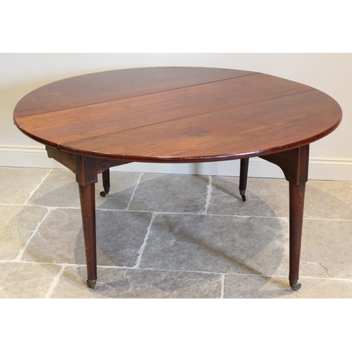 624 - A George III oval drop leaf table, the mahogany top raised upon associated oak legs of tapering cyli... 