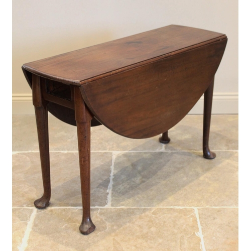 625 - A George III mahogany drop leaf table, the oval top on cylindrical tapering legs terminating in pad ... 