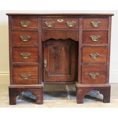 631 - A George III mahogany kneehole desk, with an arrangement of nine drawers embracing the central reces... 