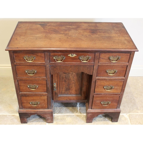 631 - A George III mahogany kneehole desk, with an arrangement of nine drawers embracing the central reces... 