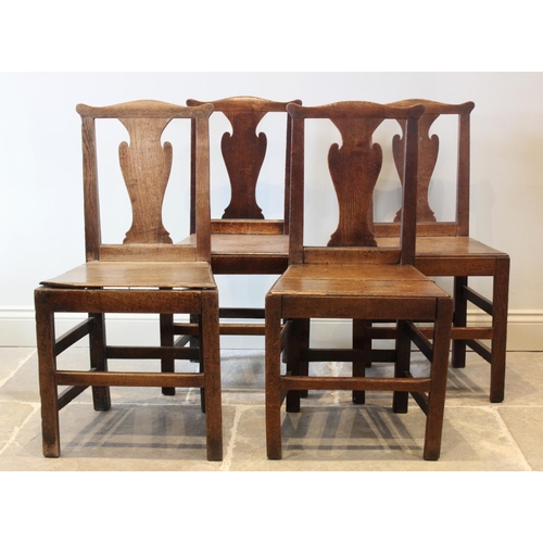 632 - A set of six George III oak country chairs, each with a cupids bow top rail above a vase shaped spla... 