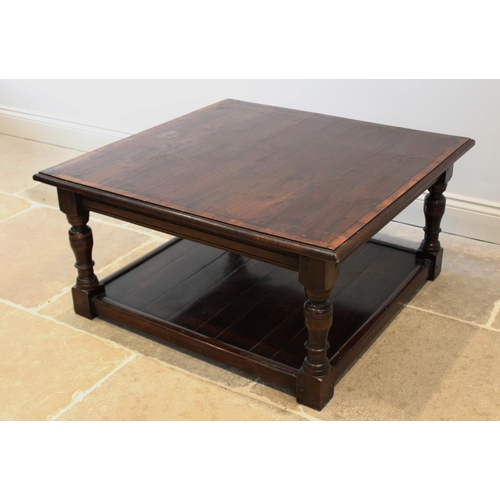 633 - A George III influence oak coffee table, late 20th century, the square cross banded top raised upon ... 