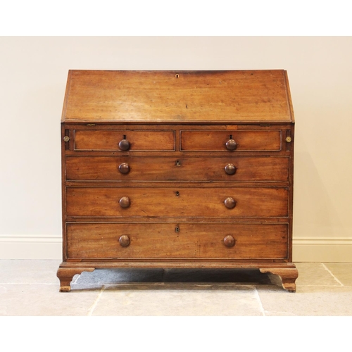 636 - A George III mahogany bureau, the fall front opening to a compartmentalised interior, over two short... 