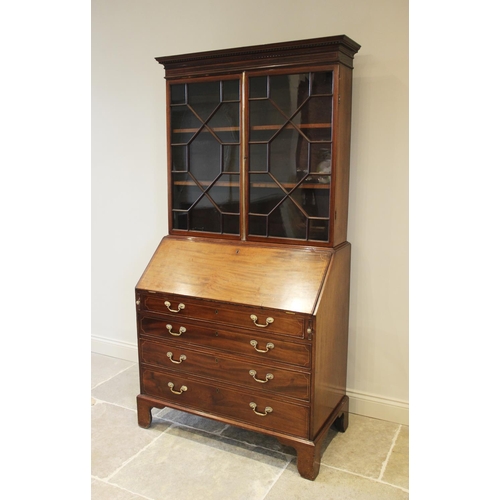 637 - A 19th century mahogany bureau bookcase, the dentil cornice above a pair of astragal glazed doors en... 