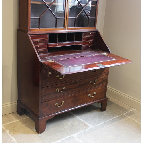 637 - A 19th century mahogany bureau bookcase, the dentil cornice above a pair of astragal glazed doors en... 