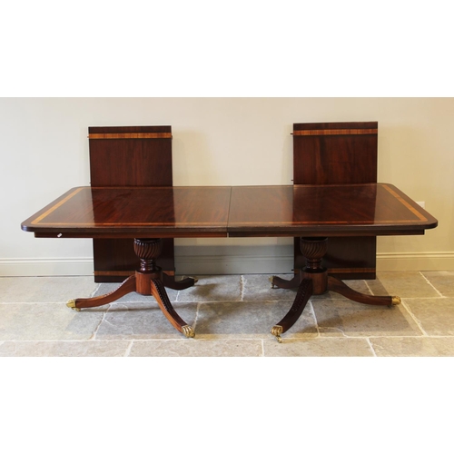 641 - A Regency style twin pillar mahogany dining table, late 20th century, the rectangular satinwood cros... 