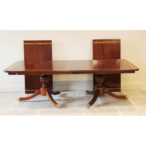 641 - A Regency style twin pillar mahogany dining table, late 20th century, the rectangular satinwood cros... 