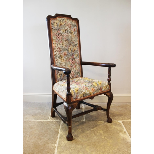 657 - A Queen Anne style chair, 19th century, the oak frame enclosing an upholstered high back above a pad... 