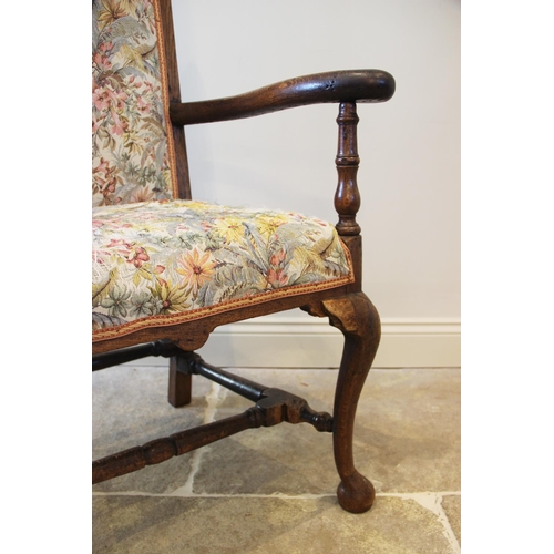 657 - A Queen Anne style chair, 19th century, the oak frame enclosing an upholstered high back above a pad... 