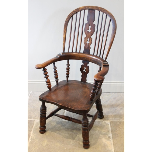 663 - A 19th century elm, ash and beech hoop back Windsor farmhouse chair, the central pierced splat flank... 