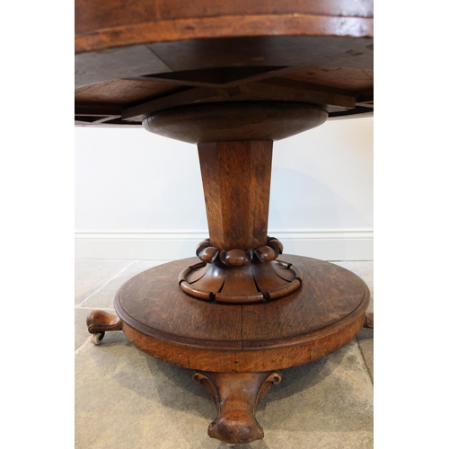 664 - A mid 19th century golden oak library drum table, the moulded circular top with an inset skiver, abo... 