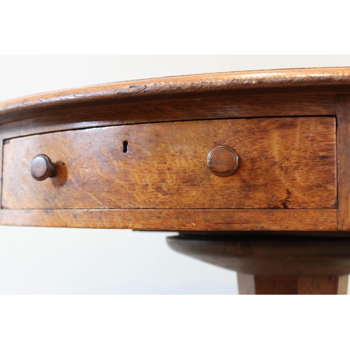 664 - A mid 19th century golden oak library drum table, the moulded circular top with an inset skiver, abo... 