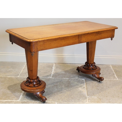 665 - A Victorian golden oak side table, the rectangular moulded top above a pair of concealed frieze draw... 