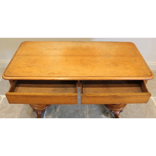 665 - A Victorian golden oak side table, the rectangular moulded top above a pair of concealed frieze draw... 