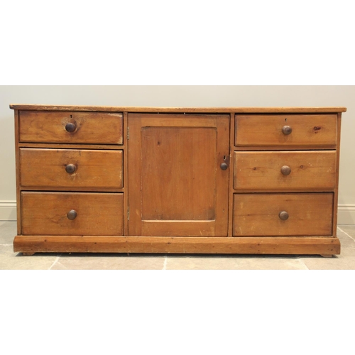 673 - A Victorian pine kitchen dresser base, the rectangular top with rounded front corners above a centra... 