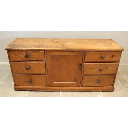 673 - A Victorian pine kitchen dresser base, the rectangular top with rounded front corners above a centra... 