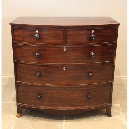 674 - An early 19th century mahogany bow front chest of drawers, with an arrangement of two short over thr... 