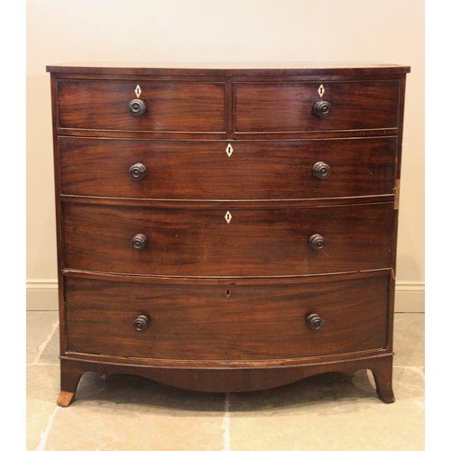 674 - An early 19th century mahogany bow front chest of drawers, with an arrangement of two short over thr... 