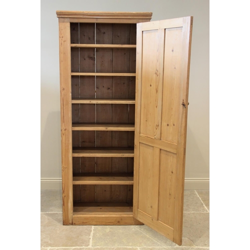 679 - A Victorian pine kitchen cupboard, the single quatre panelled door opening to six fixed shelves, bel... 