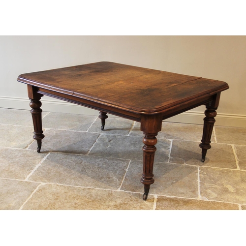 686 - A Victorian mahogany extending dining table, the rectangular moulded top with rounded corners, raise... 