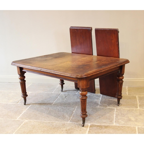 686 - A Victorian mahogany extending dining table, the rectangular moulded top with rounded corners, raise... 