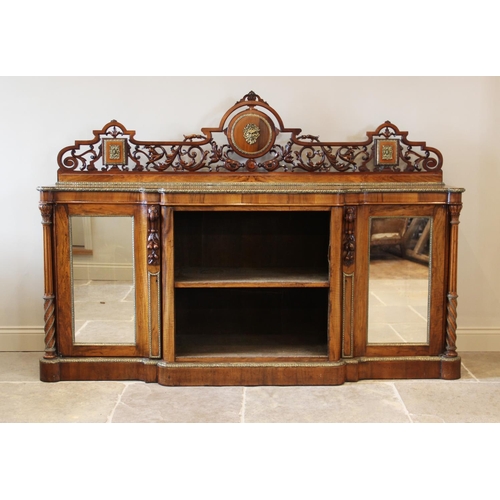 691 - A mid 19th century burr walnut breakfront credenza, the scrolling foliate openwork back rail centred... 