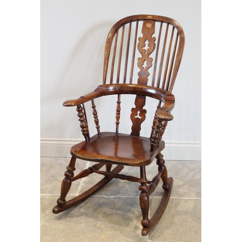 695 - A Victorian and later stained elm and ash Windsor farmhouse rocking chair, the hoop back with centra... 