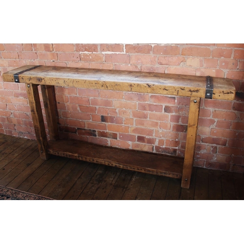 706 - A rustic hardwood and iron bound console table, the slab top applied with rivet detail iron work, up... 