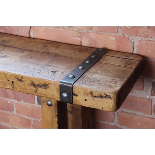 706 - A rustic hardwood and iron bound console table, the slab top applied with rivet detail iron work, up... 