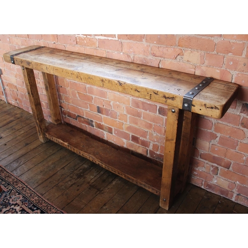 706 - A rustic hardwood and iron bound console table, the slab top applied with rivet detail iron work, up... 