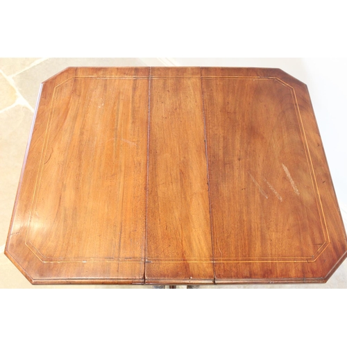 708 - An Edwardian mahogany Sutherland table, the rectangular drop leaf top with inlaid stringing and cant... 