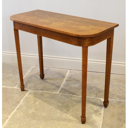 711 - An Arts & Crafts honey oak side table, the rectangular top with rounded front corners, raised upon l... 