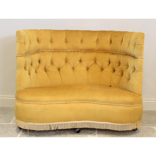 713 - An early 20th century button back love seat, upholstered in yellow velour, the wrap around high back... 